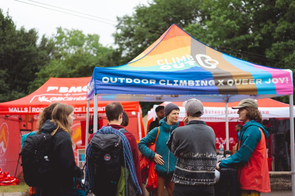Community Programme 2 Climbers at a community stand at ClimbOut queer climbing festival